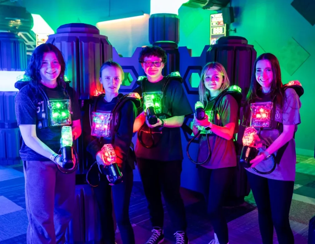 Group of teens playing laser tag at XtremeCraze Foxborough party arena
